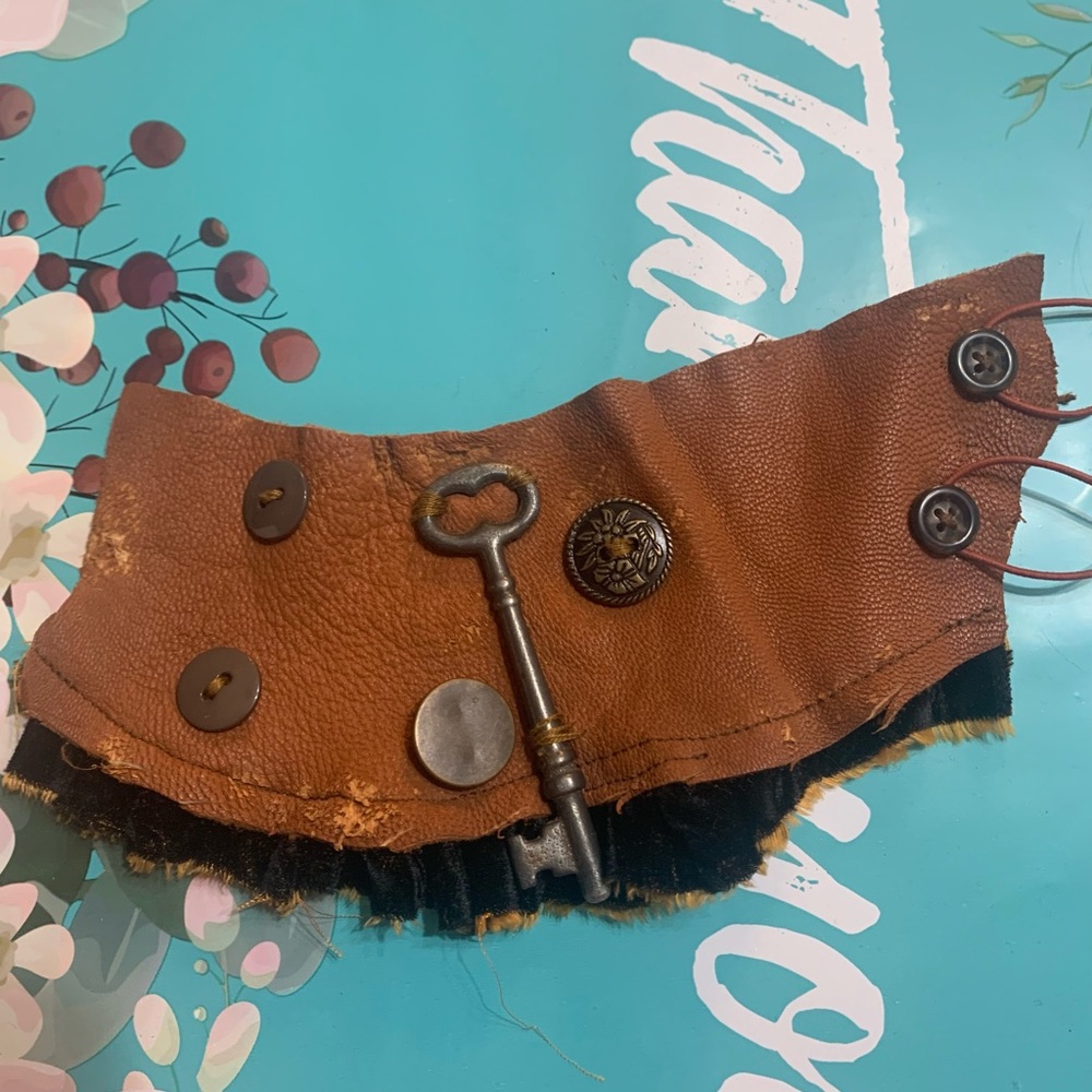 Leather and velvet cuff bracelet.